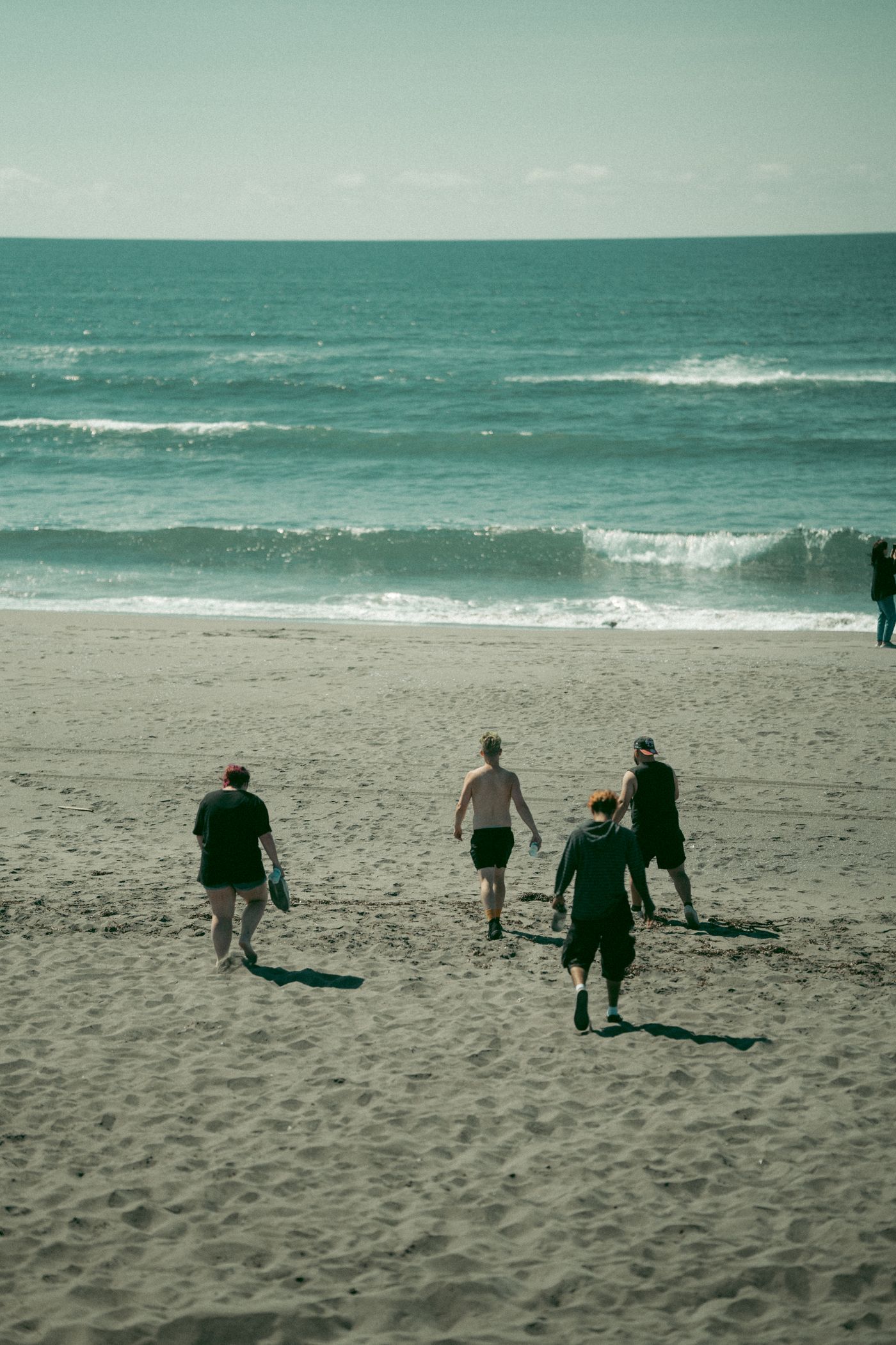 People walking on a sandy beach
