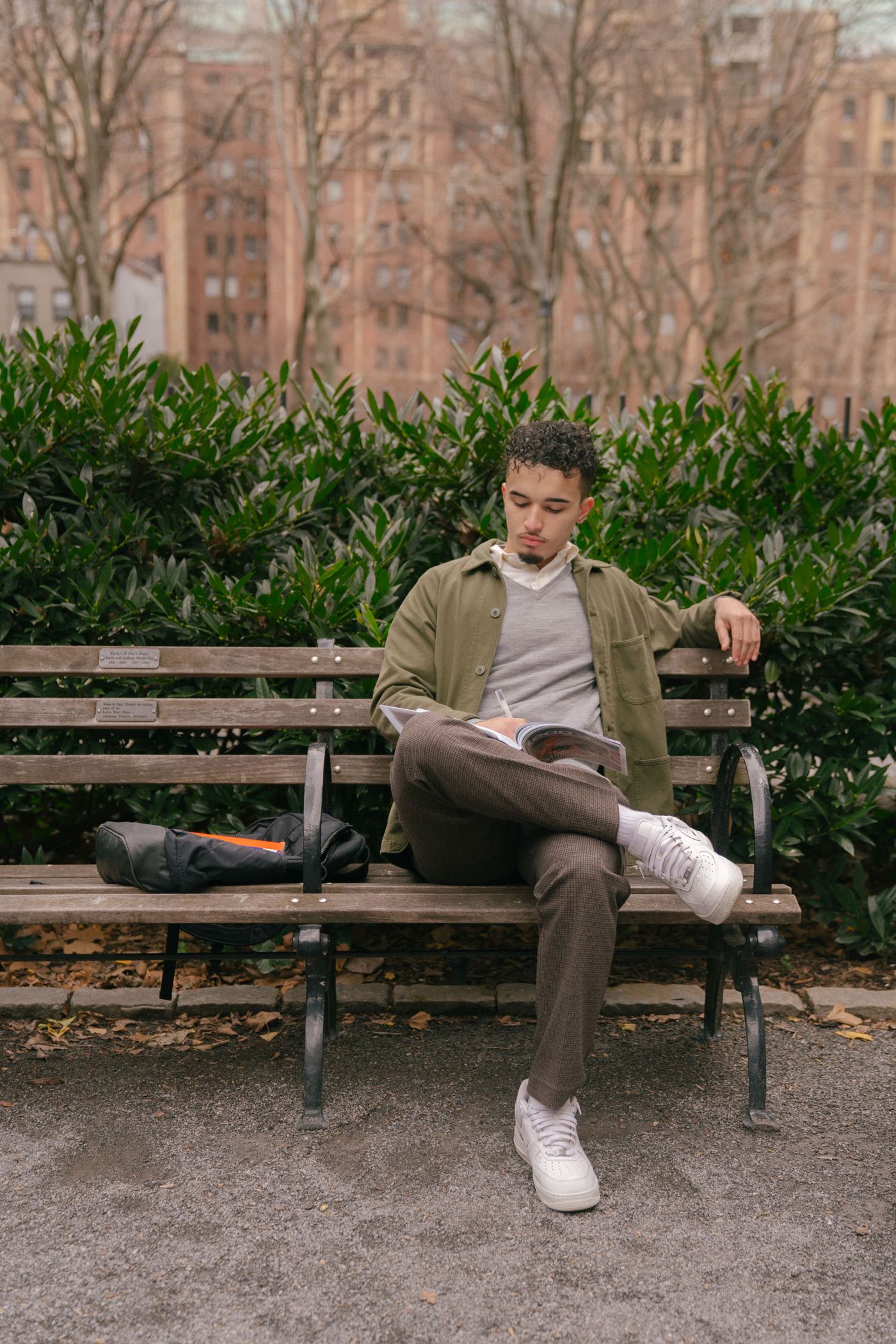 A reader sitting on a park bench