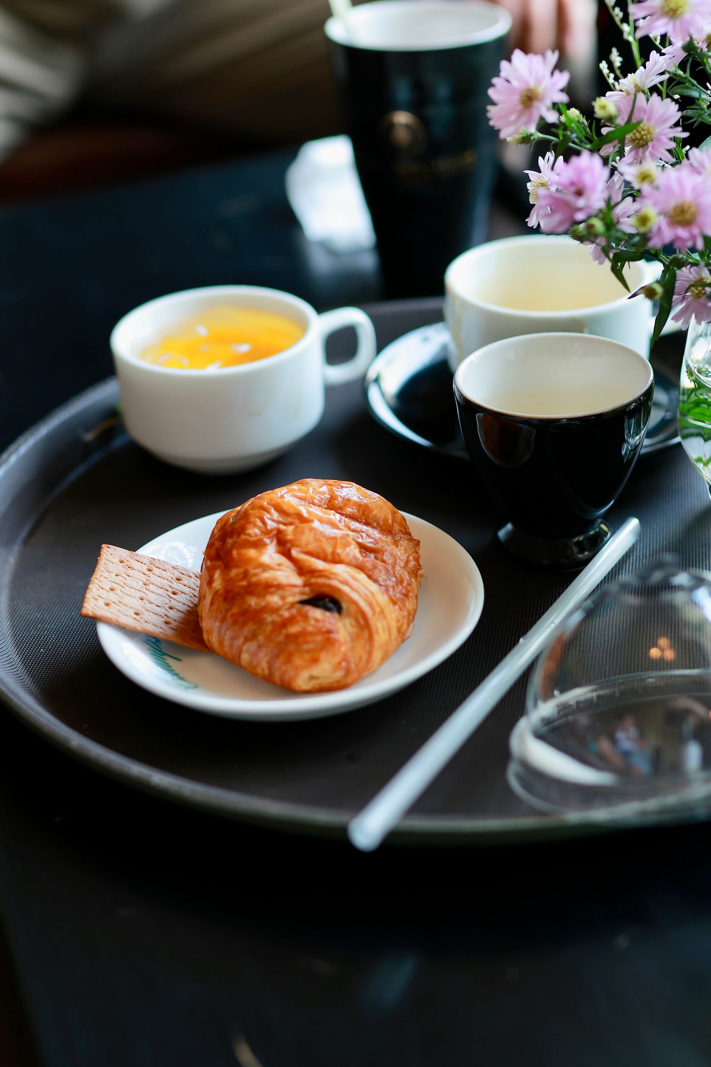 Breakfast tray with a croissant and tea