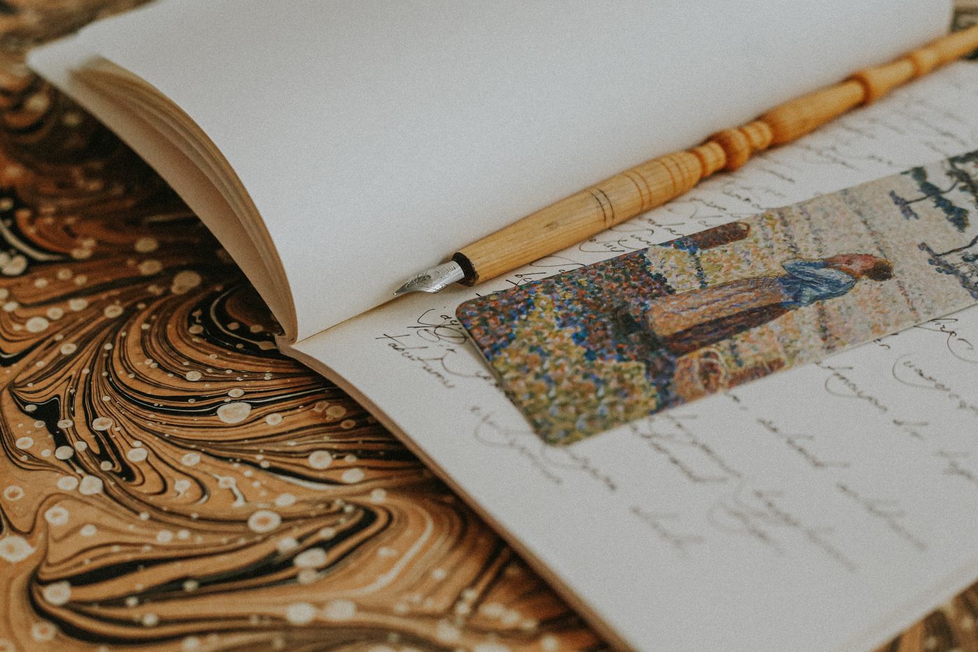 Open notebook with a pen and bookmark