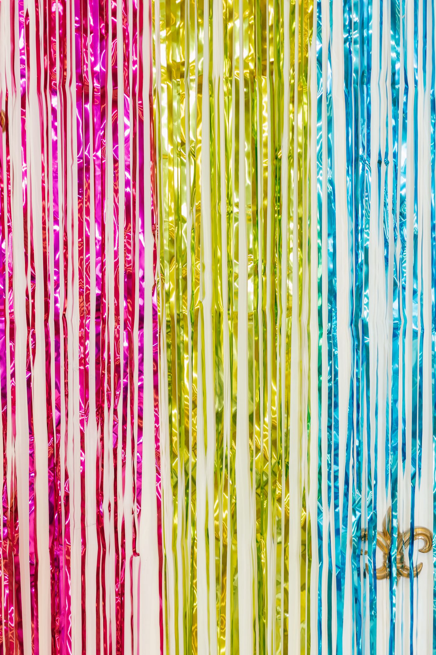 Party backdrop made from coloured foil strips