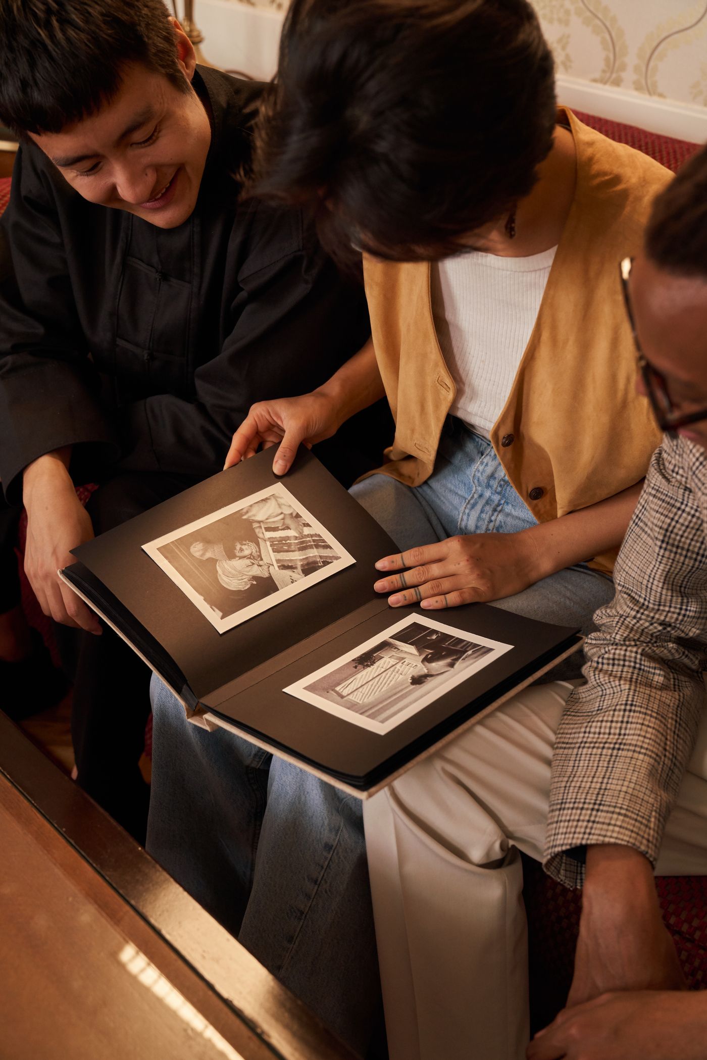 Family looking at an album of old photographs