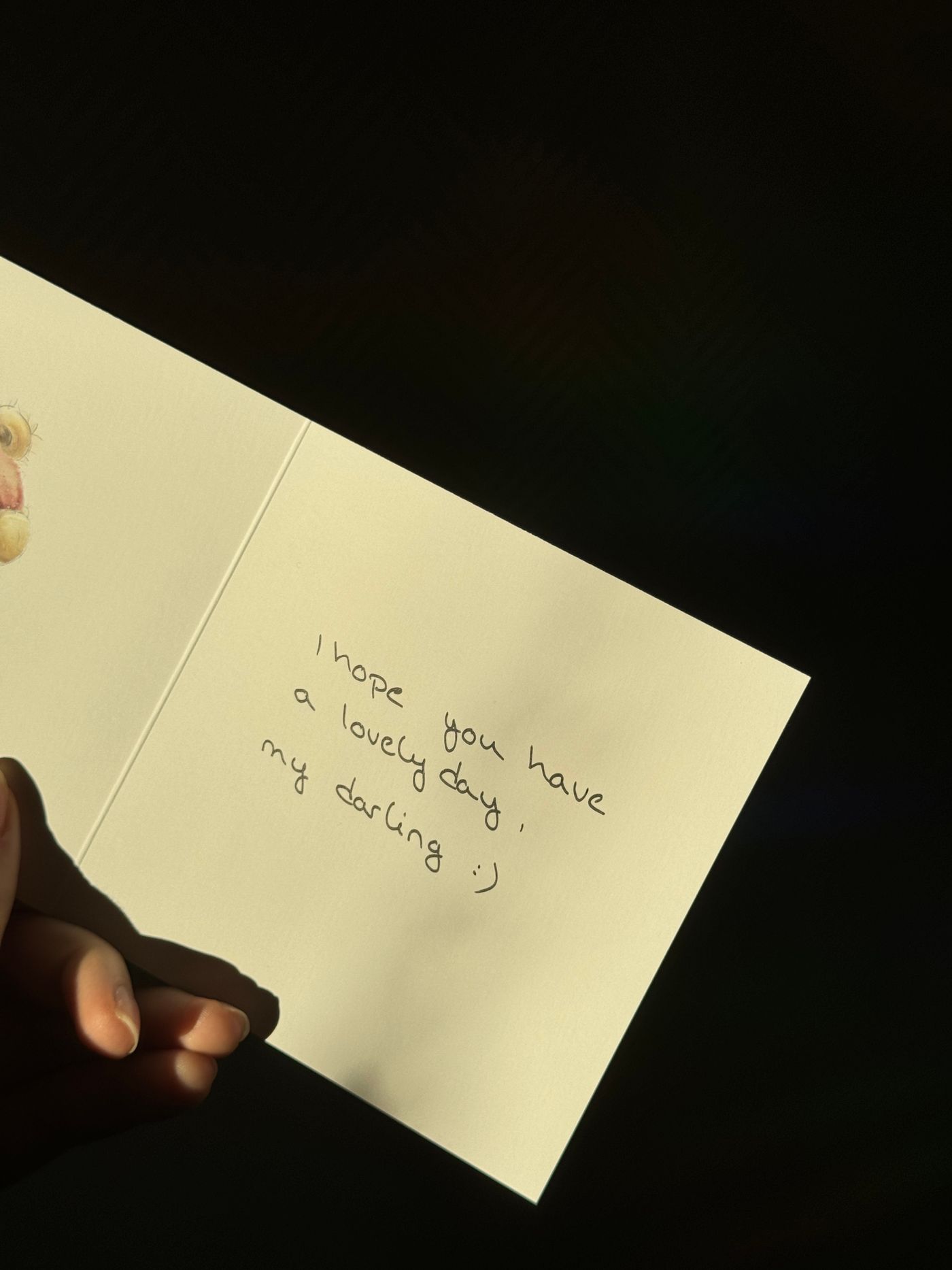 Card with a handwritten message held in a hand