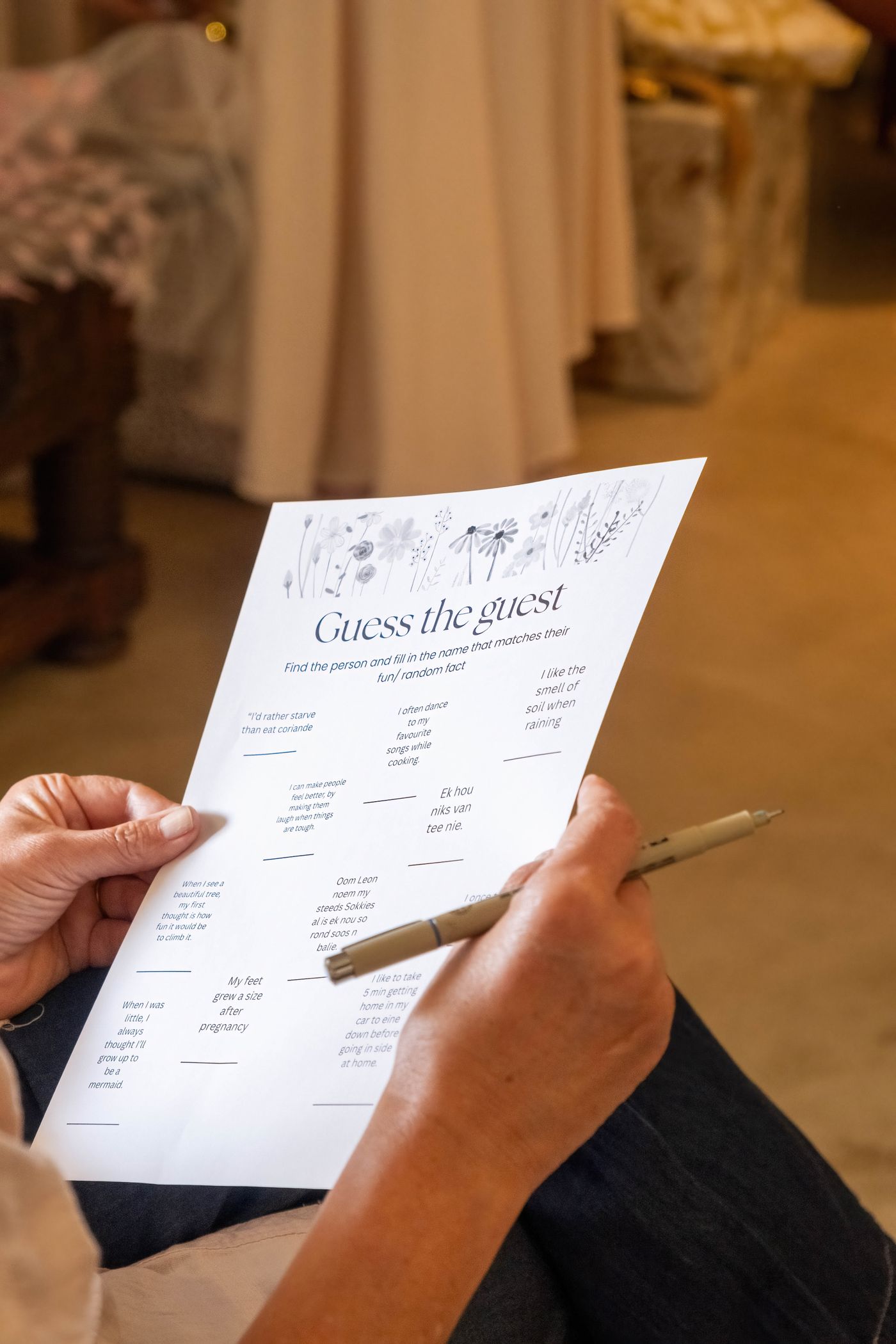 A question-game sheet held in a hand