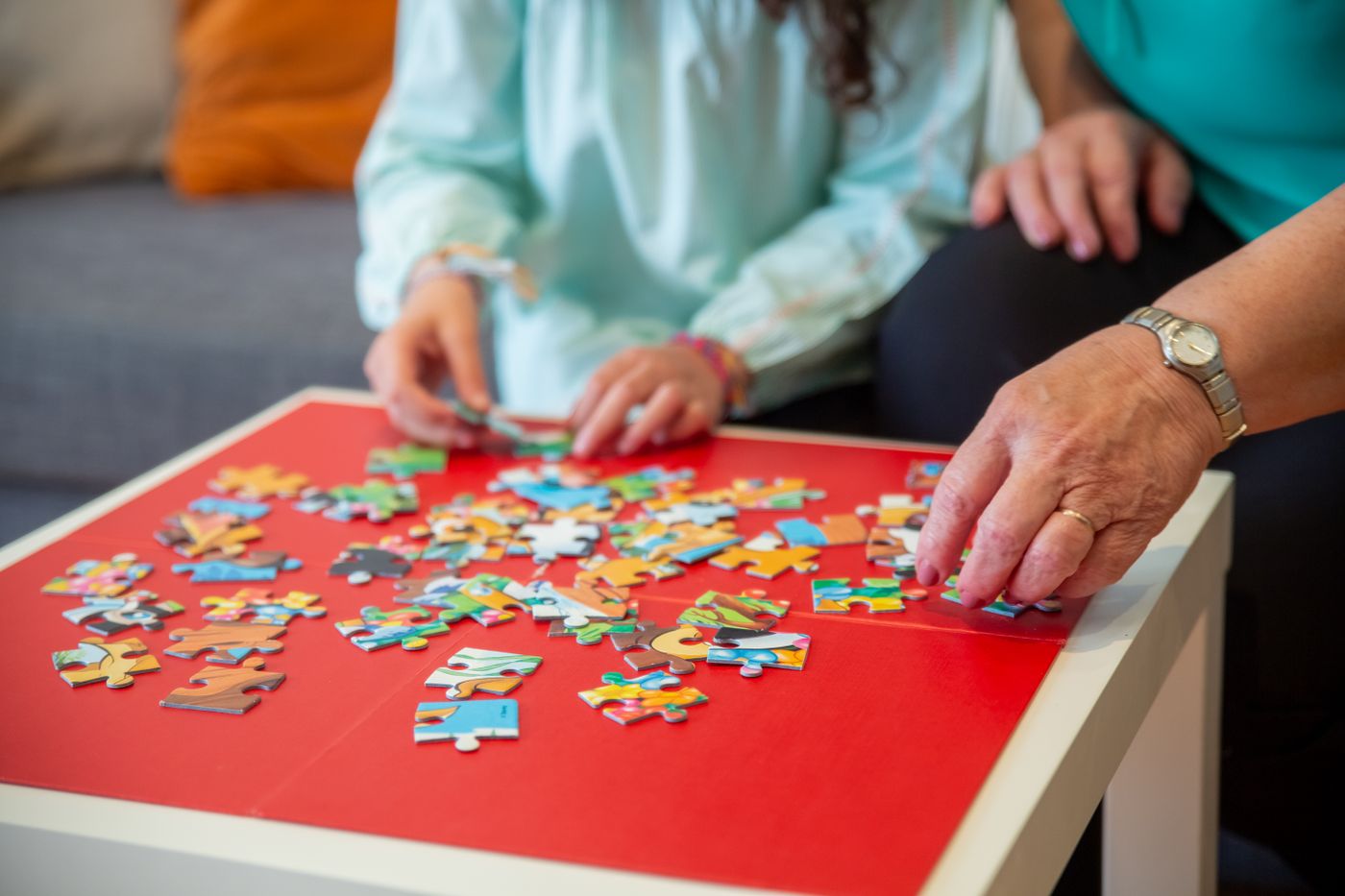 People assembling a jigsaw puzzle