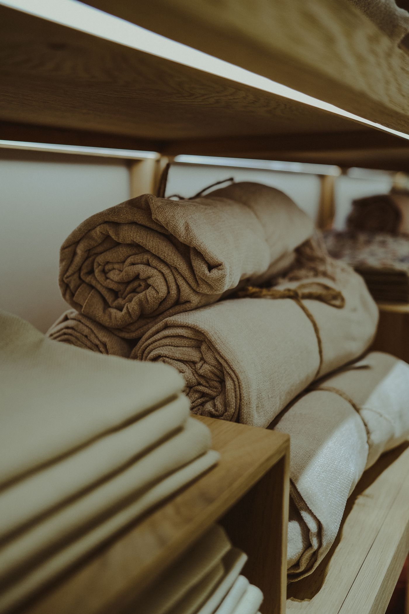 Rolled household linens arranged on a shelf