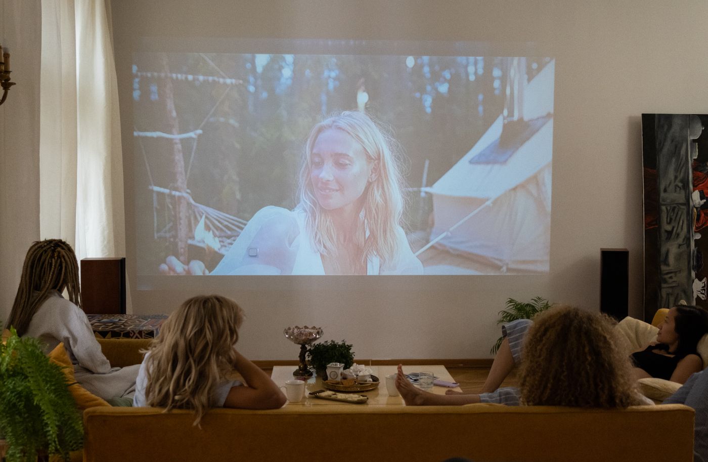Friends watching a film on a sofa