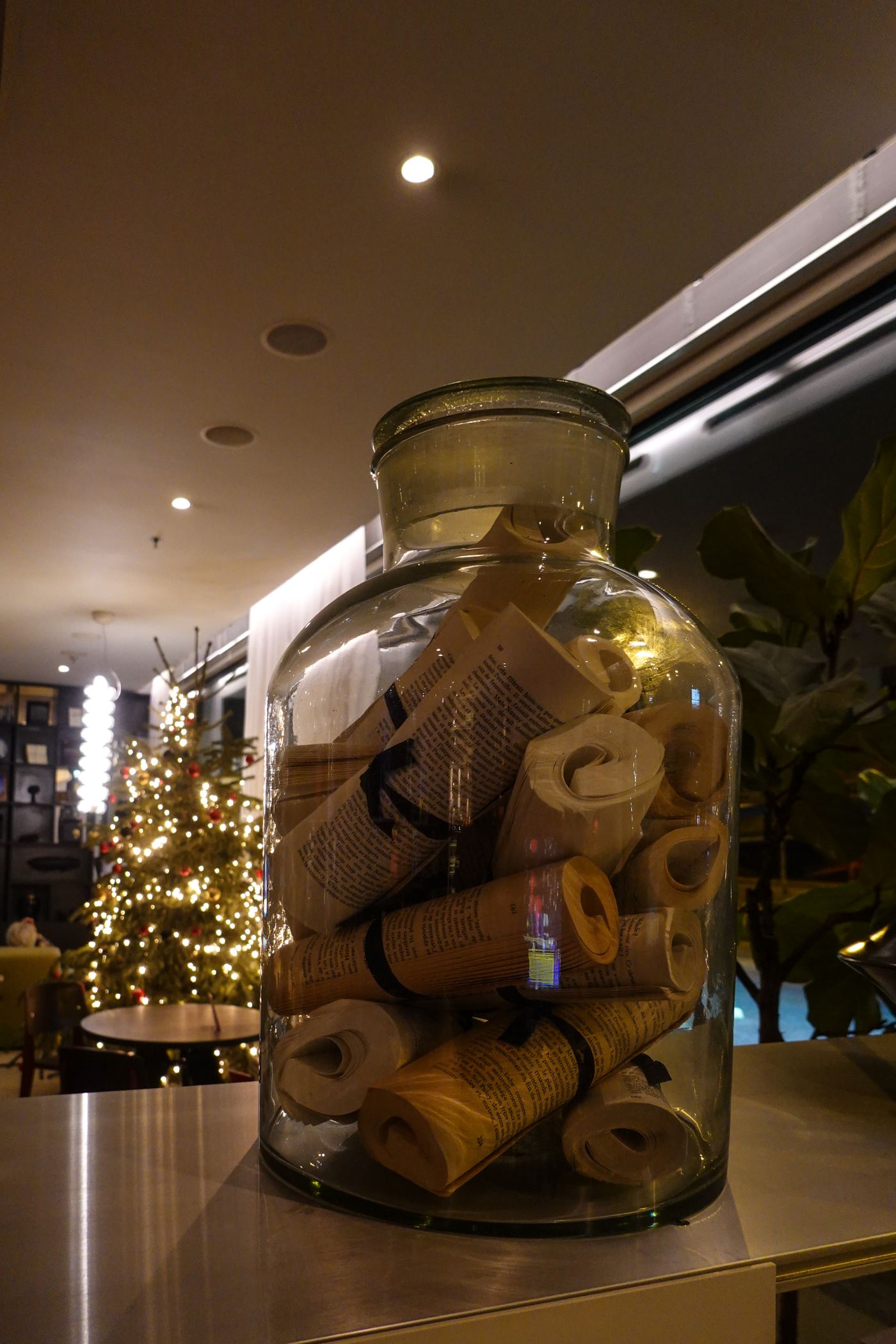 Small paper scrolls inside a glass jar