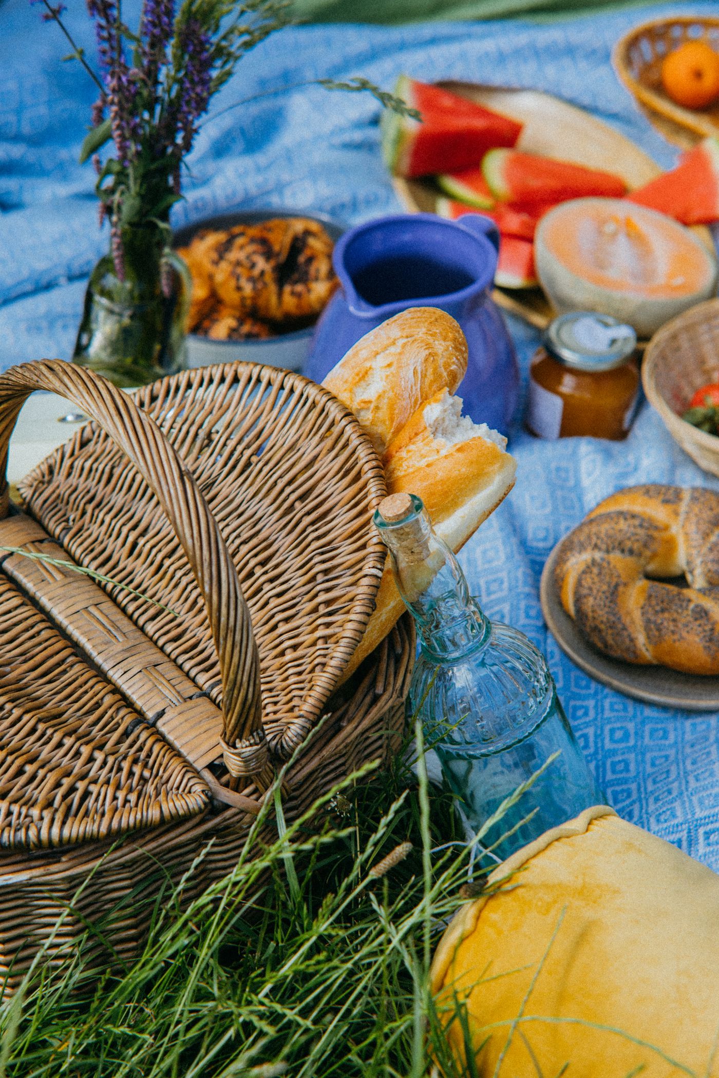 Basket and food on a picnic blanket