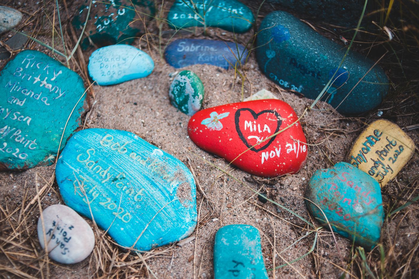 Painted pebbles on sand