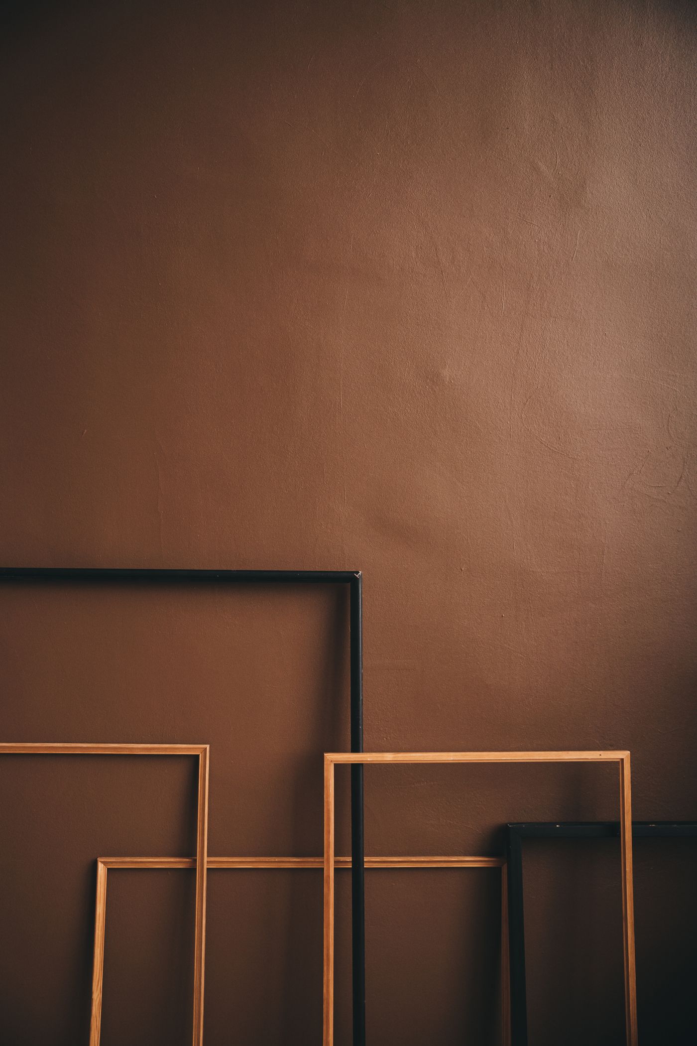 Picture frames leaning against a wall